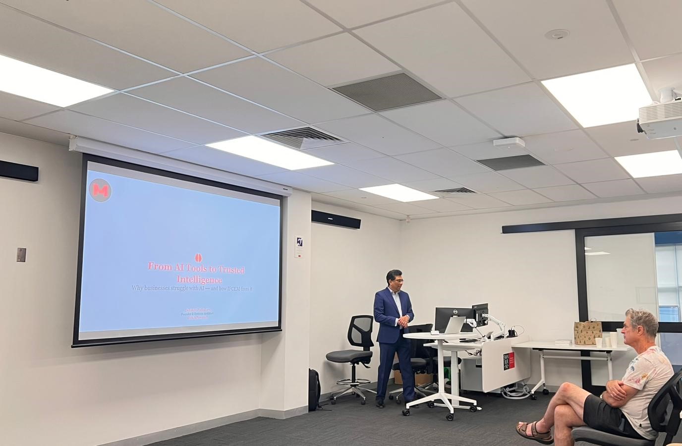 DataMPowered CEO Dakshan Pothuhera delivering keynote on practical AI governance at BizsNetwork's 2026 in-person event